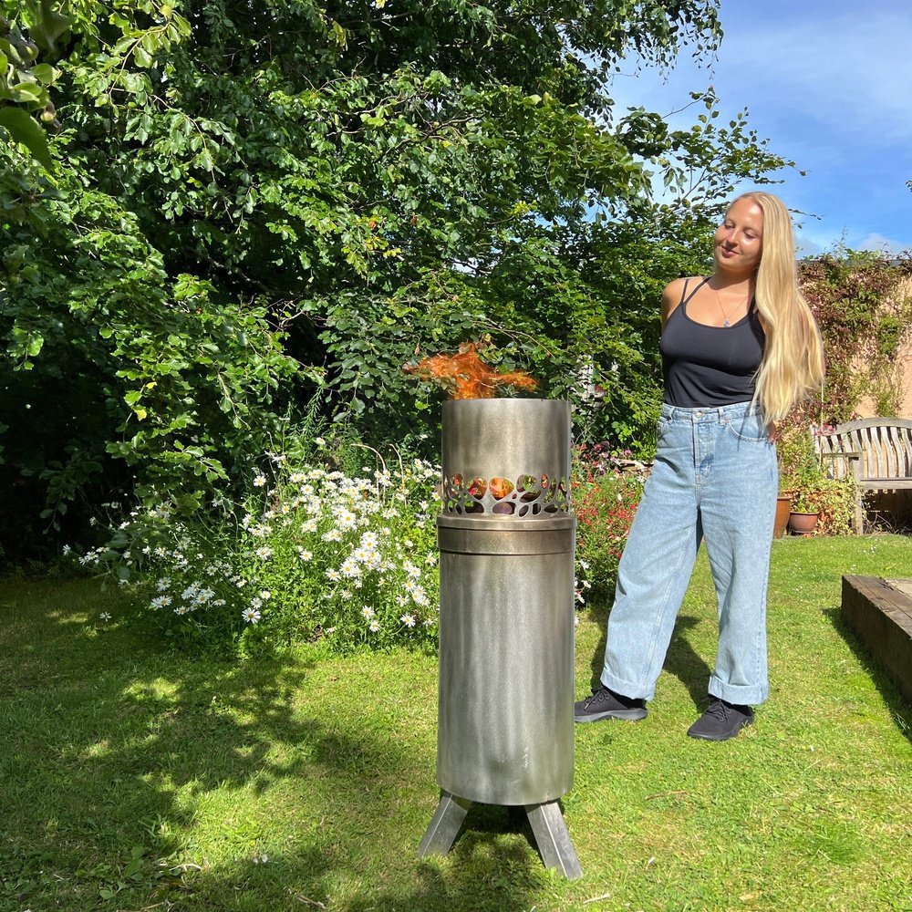 Lottie Hawkins, Founder, with Stainless Steel Biochar Kiln
